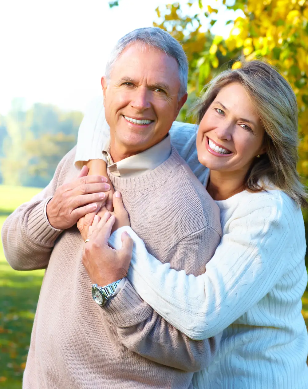Smiling older couple wearing glasses, close‑up portrait.